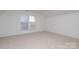 Well-lit bedroom with carpet and window with blinds at 4030 Garden Oak Dr, Indian Trail, NC 28079