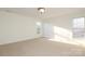 Bright bedroom with neutral carpeting and two large windows at 4030 Garden Oak Dr, Indian Trail, NC 28079