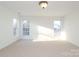 Bright bedroom with neutral carpeting and two large windows at 4030 Garden Oak Dr, Indian Trail, NC 28079