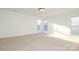 Bright bedroom with neutral carpeting and multiple windows at 4030 Garden Oak Dr, Indian Trail, NC 28079