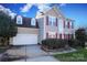 Two-story house with gray siding, red shutters, and a two-car garage at 4030 Garden Oak Dr, Indian Trail, NC 28079