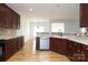 Spacious kitchen with dark wood cabinets, tile backsplash, and hardwood floors at 4030 Garden Oak Dr, Indian Trail, NC 28079