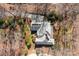 Stunning aerial view of a home nestled among trees, featuring a well-manicured lawn and a spacious driveway at 411 Major Run, Cramerton, NC 28032