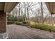 Spacious backyard with a wooden deck, bench seating, and lush greenery at 411 Major Run, Cramerton, NC 28032