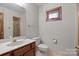 Cozy bathroom with a shower, toilet, sink, and a window at 411 Major Run, Cramerton, NC 28032