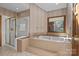 A bath features a tub with gold fixtures and a separate shower with glass doors at 411 Major Run, Cramerton, NC 28032