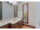 A sink with wood vanity features a mirror and a window for natural light at 411 Major Run, Cramerton, NC 28032