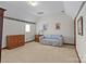 Comfortable bedroom featuring neutral carpet, a cozy couch, and a dresser for ample storage at 411 Major Run, Cramerton, NC 28032