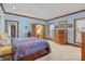 A calm bedroom has blue walls, wood trim and built-in drawers beneath the bed at 411 Major Run, Cramerton, NC 28032