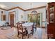 Elegant dining room featuring a large window, chandelier, and a table set for a formal dining experience at 411 Major Run, Cramerton, NC 28032