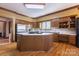 Kitchen with wood cabinets, central island, and white countertops at 411 Major Run, Cramerton, NC 28032