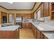 Warm, inviting kitchen featuring wood cabinetry, stainless steel appliances, and bright, modern countertops at 411 Major Run, Cramerton, NC 28032