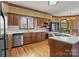 This kitchen features a stainless steel dishwasher and a peninsula with seating at 411 Major Run, Cramerton, NC 28032