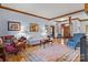 Spacious living room with hardwood floors, featuring a large rug and comfortable seating arrangements at 411 Major Run, Cramerton, NC 28032