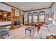 Bright living room with hardwood floors, a brick fireplace, and large windows offering natural light and cozy atmosphere at 411 Major Run, Cramerton, NC 28032
