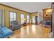 Spacious living room with hardwood floors, large windows, and a brick fireplace, perfect for entertaining at 411 Major Run, Cramerton, NC 28032