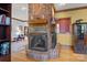 Cozy living room features a brick fireplace, hardwood floors, and open view of the elegant adjacent space at 411 Major Run, Cramerton, NC 28032