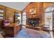 A traditional office features a brick fireplace and wood paneled walls at 411 Major Run, Cramerton, NC 28032