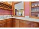Charming wet bar with wooden cabinets, a sink, and a wine rack, perfect for entertaining guests in style at 411 Major Run, Cramerton, NC 28032