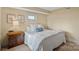 Guest bedroom with wooden nightstand and bedding at 503 Barber Loop, Mooresville, NC 28117