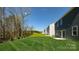 Spacious backyard with lush green grass and a view of wooded area at 5149 Fireweed Ct, Dallas, NC 28034