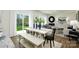 Open concept kitchen, dining area, and living room with hardwood floors and white farmhouse table at 5149 Fireweed Ct, Dallas, NC 28034