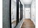 Bright entryway with hardwood floors, three mirrors, and French doors at 5149 Fireweed Ct, Dallas, NC 28034