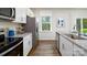 Modern kitchen with white cabinets, granite countertops, and stainless steel appliances at 5149 Fireweed Ct, Dallas, NC 28034