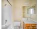 Clean bathroom with a bathtub, toilet and sink at 6303 Windsor Gate Ln, Charlotte, NC 28215