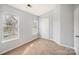 Bright bedroom with neutral walls and carpeting at 6303 Windsor Gate Ln, Charlotte, NC 28215