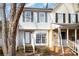 Inviting exterior of a charming townhome, featuring a brick facade and a welcoming front porch at 6303 Windsor Gate Ln, Charlotte, NC 28215