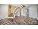 Spacious living room with gray walls, hardwood floors, and a staircase leading upstairs at 6303 Windsor Gate Ln, Charlotte, NC 28215