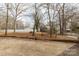 Large backyard with mature trees and a paved patio at 664 Freemont Dr, Lancaster, SC 29720