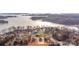 Breathtaking aerial view of waterfront homes nestled amidst lush trees and the tranquil lake, with construction underway on new properties at 8078 Blackwood Rd, Denver, NC 28037