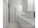 Bright bathroom featuring double sinks with marble countertops and white cabinetry at 8078 Blackwood Rd, Denver, NC 28037