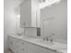 Bright bathroom featuring double sinks with marble countertops and white cabinetry at 8078 Blackwood Rd, Denver, NC 28037