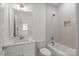 Bright bathroom featuring a modern vanity with stone countertop, shower over tub with subway tile at 8078 Blackwood Rd, Denver, NC 28037