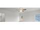 A bright bedroom is enhanced by a contemporary ceiling fan and natural light streaming through a window at 8078 Blackwood Rd, Denver, NC 28037