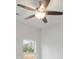 A bright bedroom is enhanced by a contemporary ceiling fan and natural light streaming through a window at 8078 Blackwood Rd, Denver, NC 28037