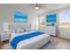 Stylish bedroom with blue accents, a plush bed, and views from two windows at 8078 Blackwood Rd, Denver, NC 28037