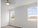 Bright, empty bedroom with hardwood floors and two windows offering a view of the outdoors at 8078 Blackwood Rd, Denver, NC 28037