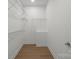 Walk-in closet offering ample storage space with wood flooring at 8078 Blackwood Rd, Denver, NC 28037