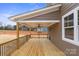 Relaxing covered deck with wooden flooring, a ceiling fan, and natural light at 8078 Blackwood Rd, Denver, NC 28037