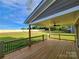 Relaxing covered deck features a ceiling fan and views of the big back yard at 8078 Blackwood Rd, Denver, NC 28037