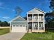 Charming two-story home with a two-car garage, enhanced by a covered porch at 8078 Blackwood Rd, Denver, NC 28037