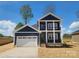 Beautiful two-story home with a two-car garage, dark navy siding, and white accents at 8078 Blackwood Rd, Denver, NC 28037