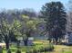 View of a new building being constructed with trees and lake in the background on a grassy lot at 8078 Blackwood Rd, Denver, NC 28037