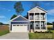 Two-story home showcasing a two-car garage and a quaint balcony at 8078 Blackwood Rd, Denver, NC 28037