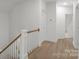 Hallway with wood flooring and white banister and staircase at 8078 Blackwood Rd, Denver, NC 28037