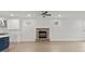 Open-concept living room with a stone fireplace and light-colored wood flooring at 8078 Blackwood Rd, Denver, NC 28037